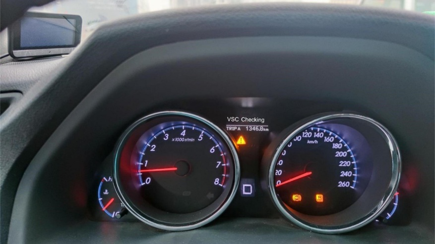 Toyota dashboard with VSC light illuminated in amber.